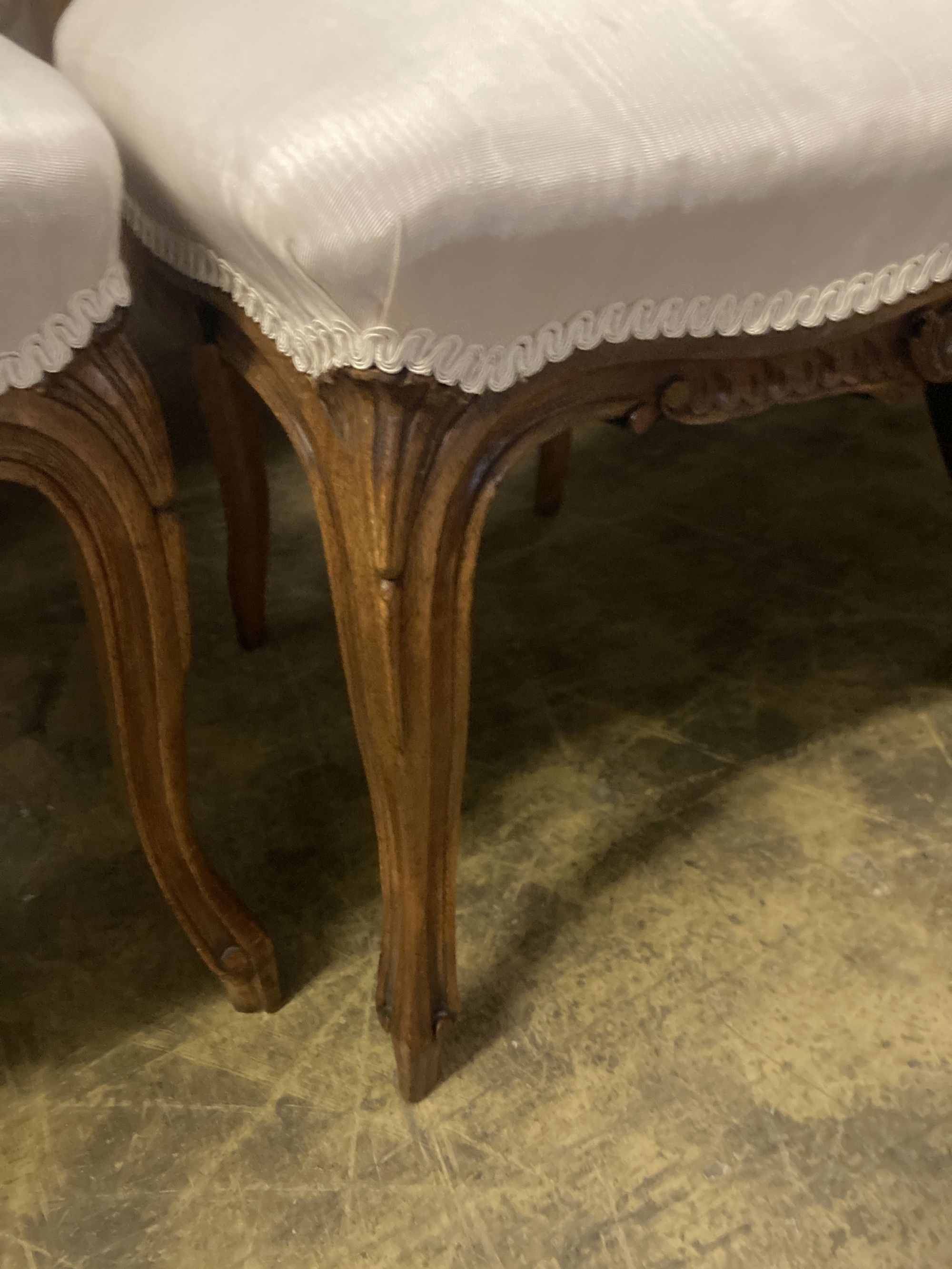 A pair of Louis XV style carved walnut side chairs